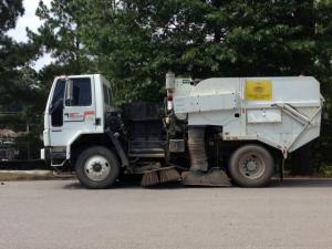 Street sweeper vehicle on the road. 